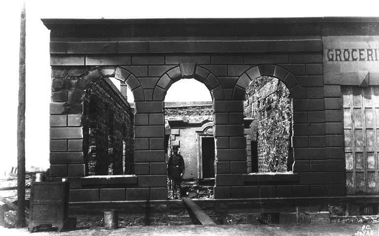 Remains of Dexter Horton &; Co. bank, 1st Ave. S. and S. Washington St., with John B. Denny of the Washington National Guard on duty, 1889