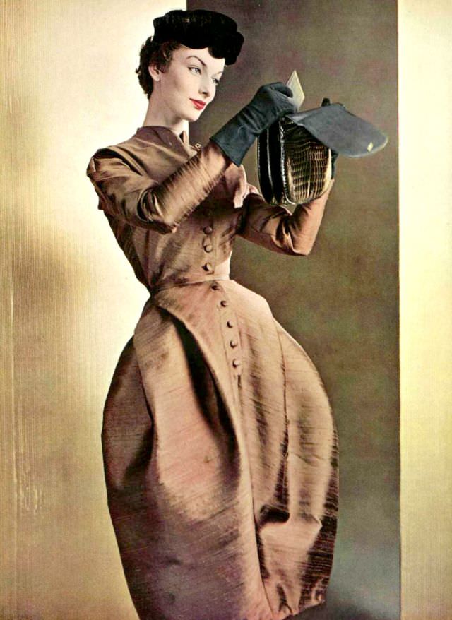 #20 Victoria von Hagen in afternoon dress of bronze silk by Jean Dessès, crocodile bag by Ferest, L’Officiel, 1953