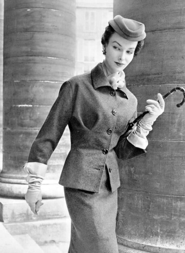 #22 Victoria von Hagen in grey flannel day suit brightened with orange mousseline scarf by Christian Dior, L’Officiel, 1953