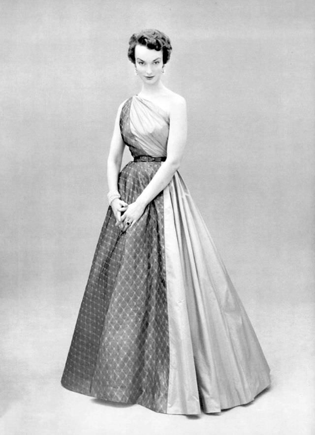 #23 Victoria von Hagen in one-shoulder evening gown of rose taffeta and gray lightweight wool by Grès, 1953