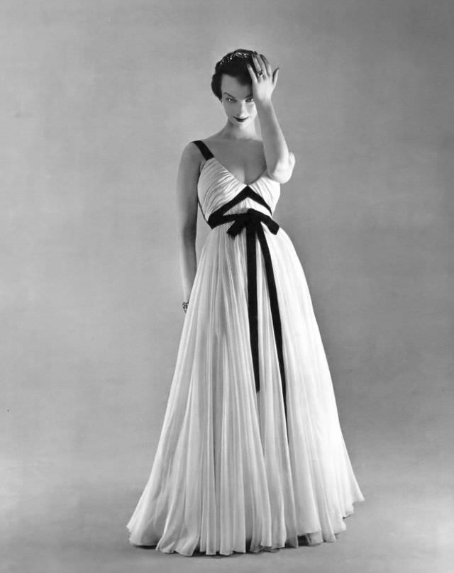 #26 Victoria von Hagen in white mousseline evening dress adorned with black ribbons by Jacques Griffe, L’Officiel, 1953