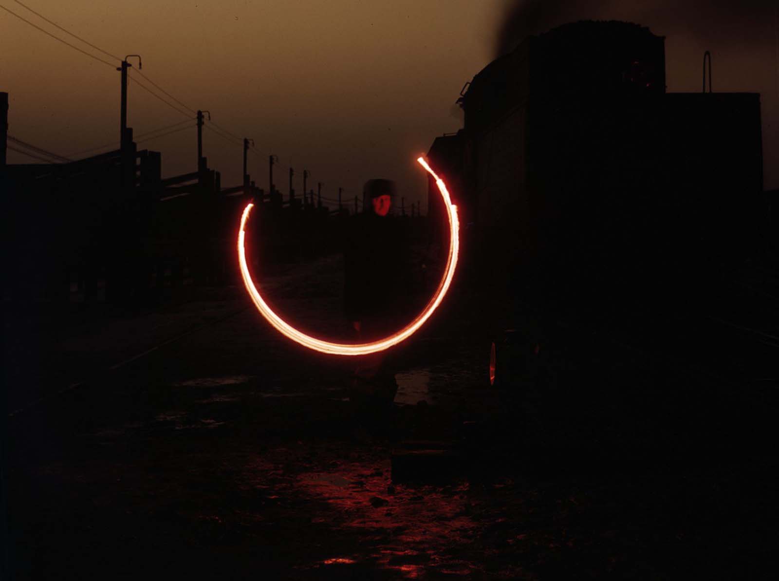 #21 An Indiana Harbor Belt Railroad switchman demonstrating a signal with a fusee, which is used at twilight and dawn when visibility is poor.