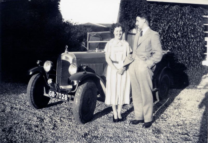 #14 A cheerful lady in a light-colored dress and a fellow wearing a suit and tie posing with an English-built Citroën 7.5 H.P. Type C, circa 1936