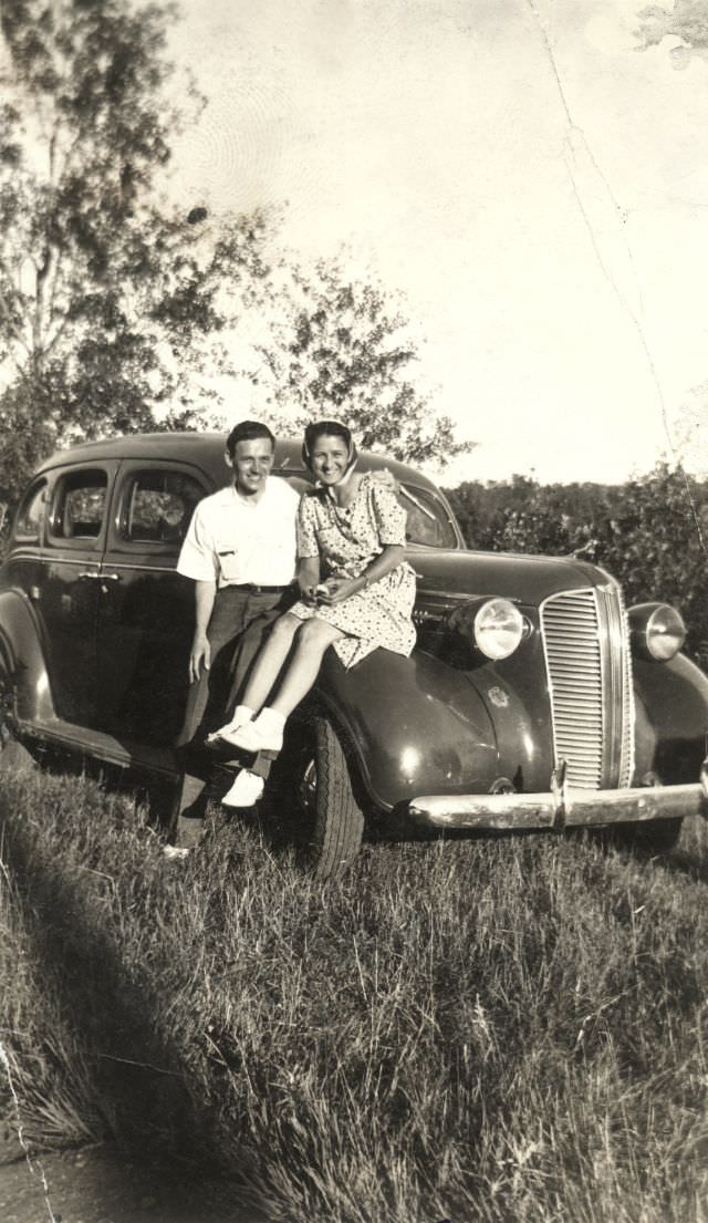 #22 A cheerful couple posing with a 1937 Dodge Sedan on a sunny summer afternoon, somewhere in Canada, 1938
