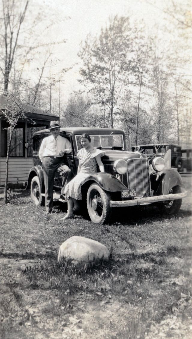 #4 A middle-class couple posing with a 1932 DeSoto Six on a sunny spring day in the countryside.