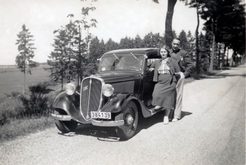 #8 A couple posing with a Fiat Balilla 508 A on a gravel road in the countryside, 1935