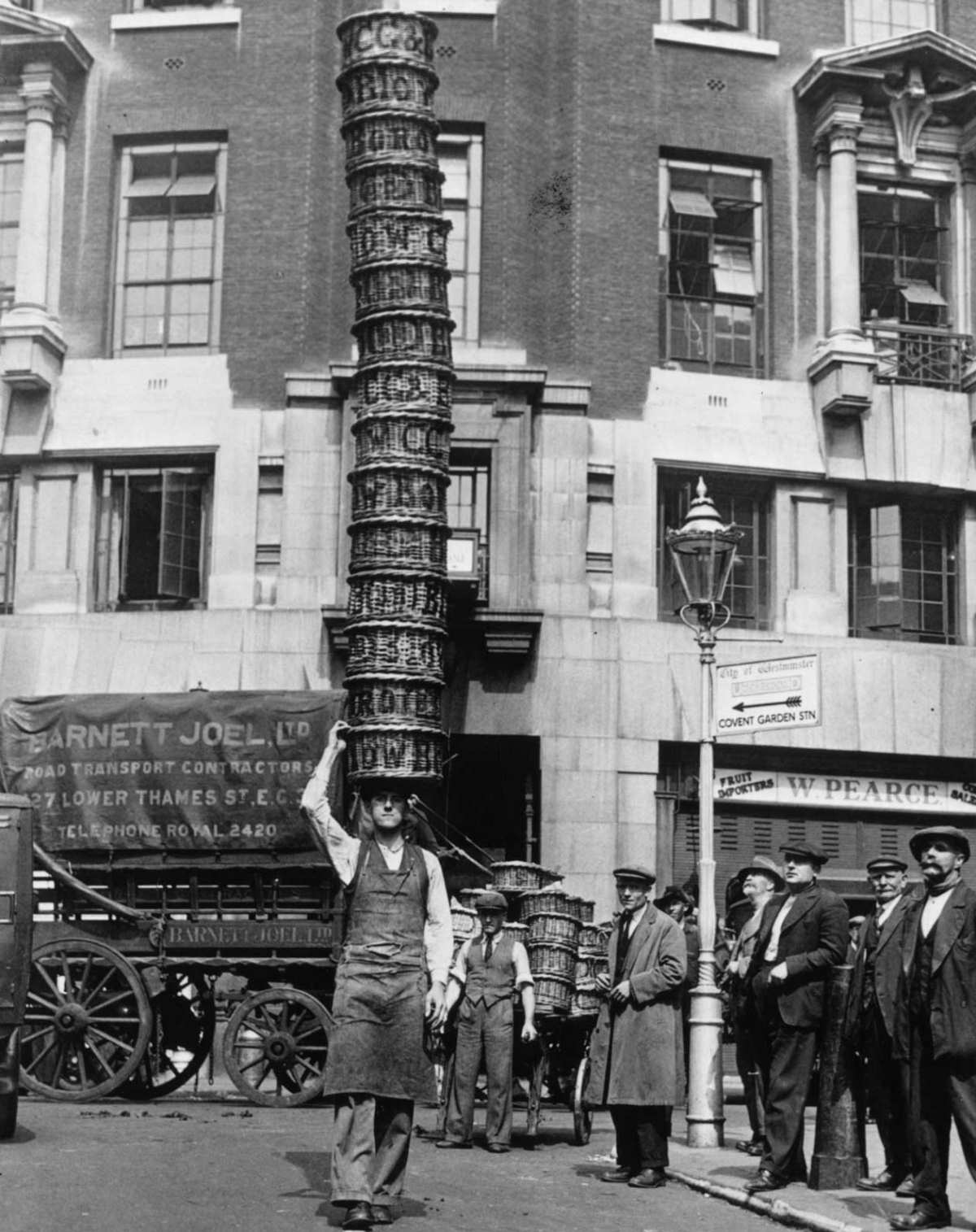 #3 Market trader Alfred Bailey practicing with 15 baskets at Covent Garden, London, for the basket-carrying championships, 1925.