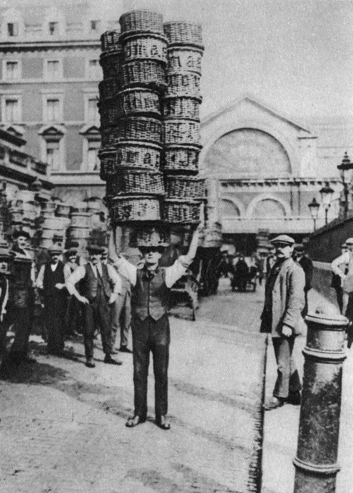 #6 A porter carrying many baskets on his head, 1926.