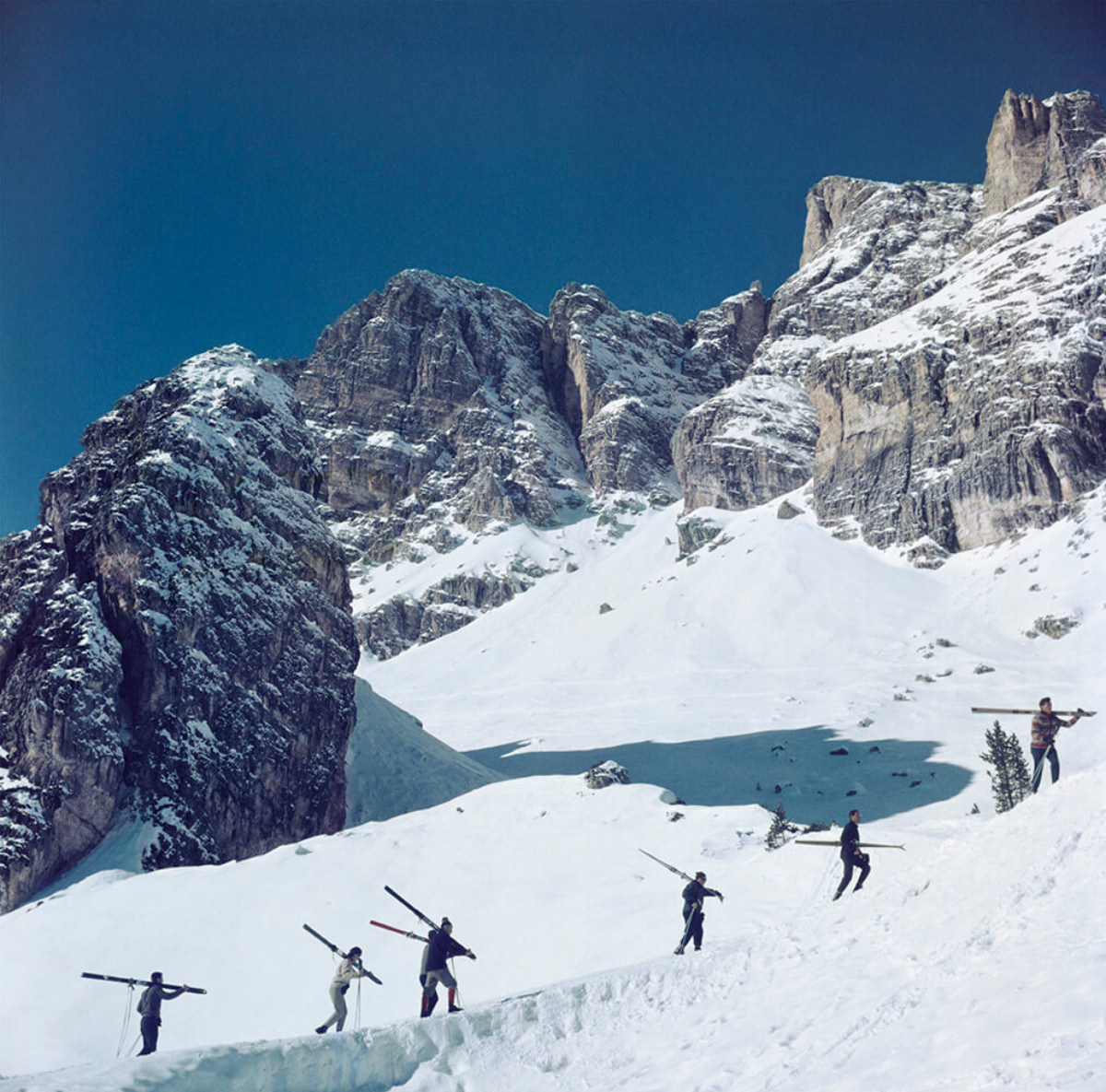 #12 Skiers walk up a mountain in Cortina D’Ampezzo, a ski resort in northern Italy, 1962.