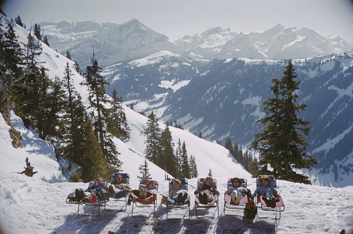 #13 Holidaymakers in sun loungers on the slopes at at Gstaad, Switzerland, March 1961.