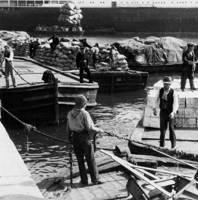 #13 Workers and seamen at a harbour.
