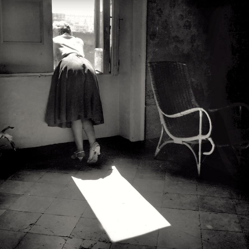 #50 Waman looking outside the window.