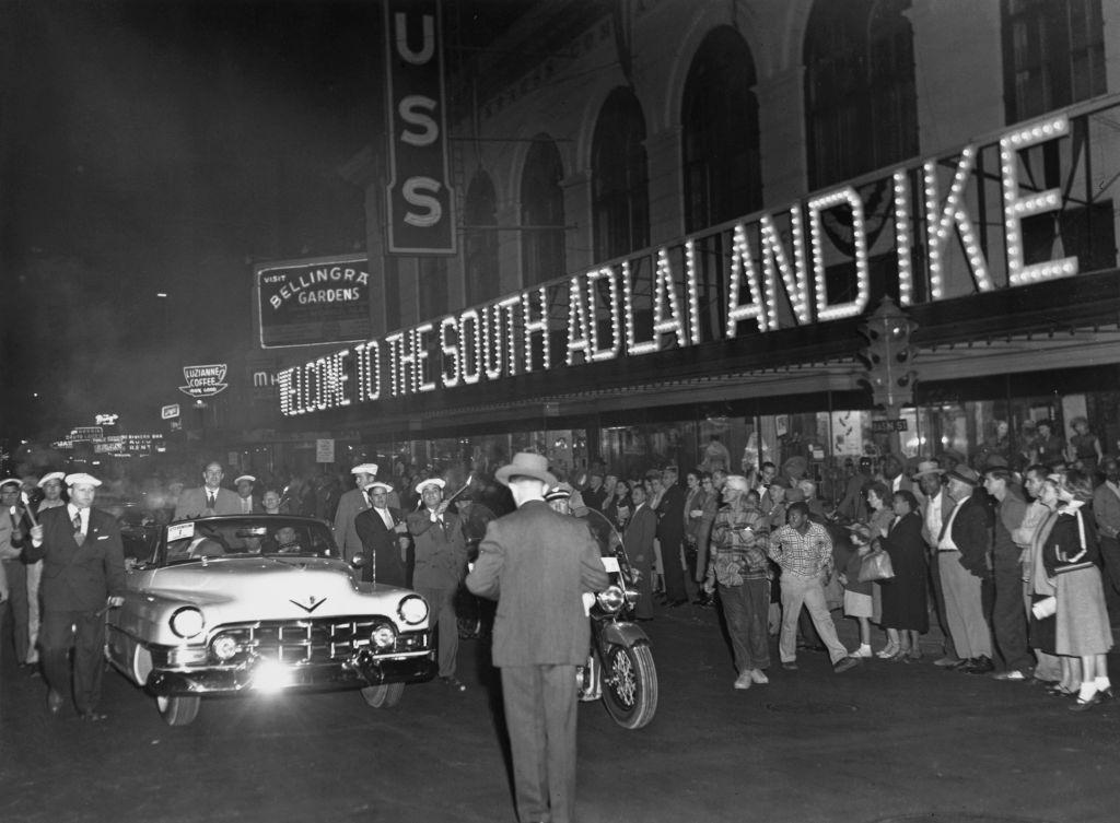 #51 The car in which Governor Adlai Stevenson drove into New Orleans from the airport after his arrival is sown passing a huge electric sign which blazes, 1952.