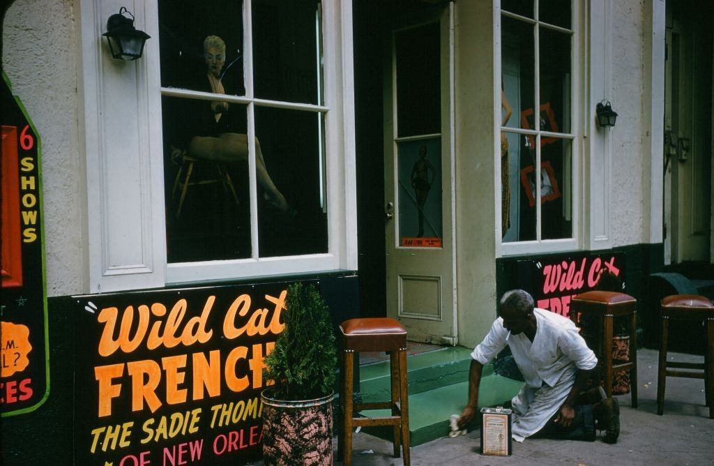 #127 A view down Bourbon street outside the Wild Cat Frenchie bar in New Orleans, 1957.