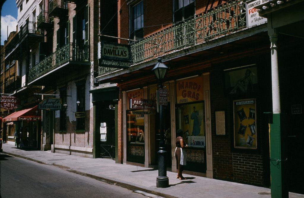 #75 A view down Bourbon street outside Mardi Gras bar and lounge in New Orleans, 1957.
