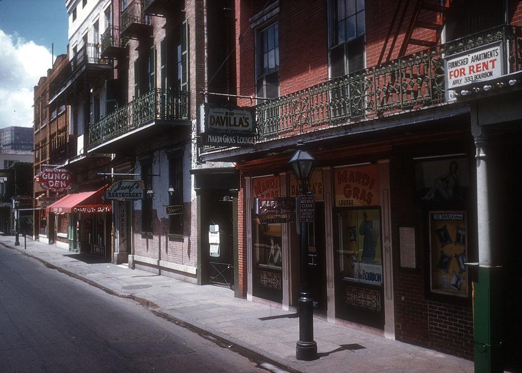 #132 Exterior of ‘The Mardi Gras Lounge’ and ‘Gunga Den’ On Bourbon Street on May 16, 1957 in New Orleans, Louisiana.