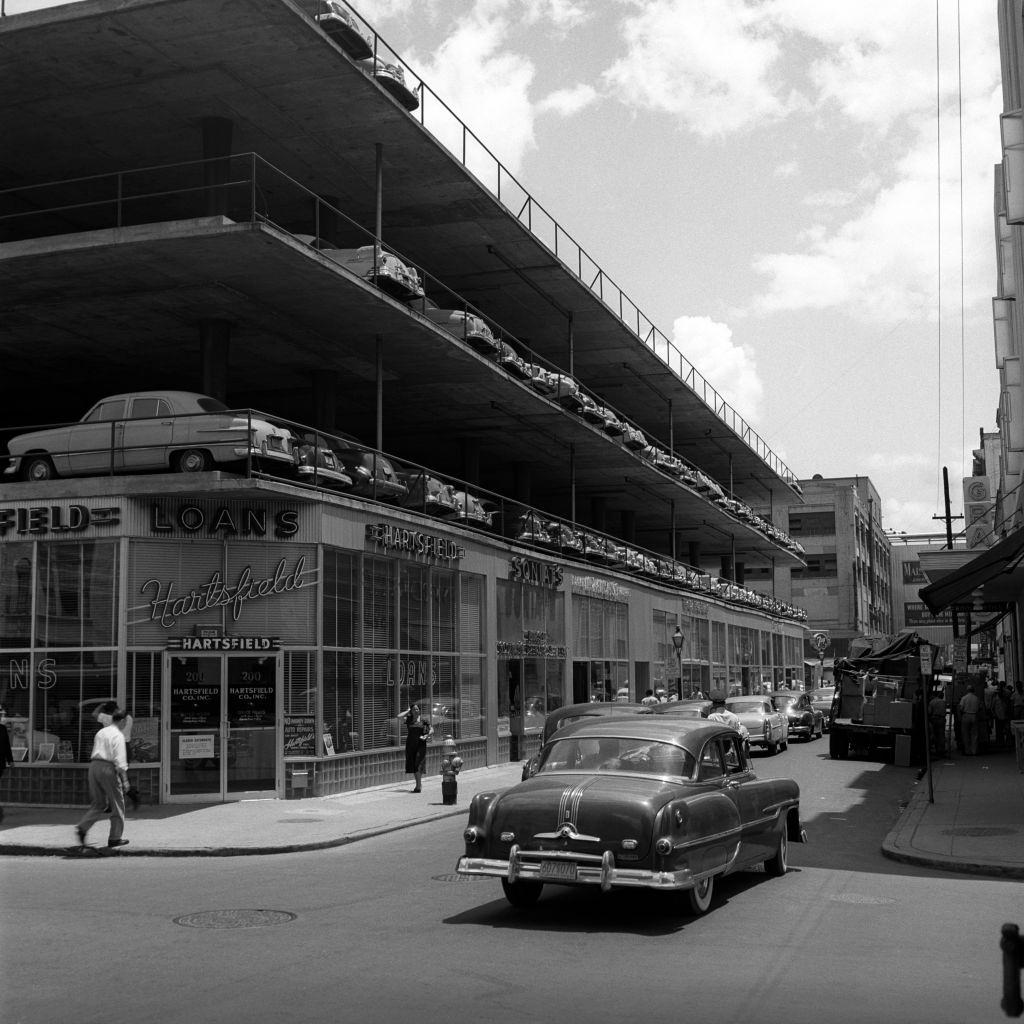 #37 Parking lot three story building architecture car on street pedestrian, New Orleans, 1950s