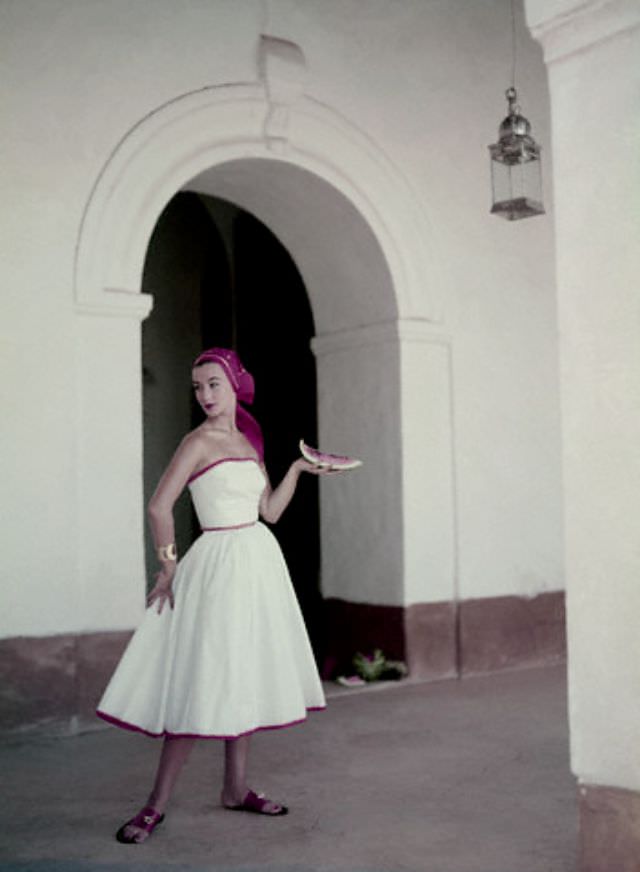 #11 Ruth Neuman Derujinsky wearing a strapless white cotton dress with a matching handkerchief by Pat Premo and Bernardo sandals, 1953