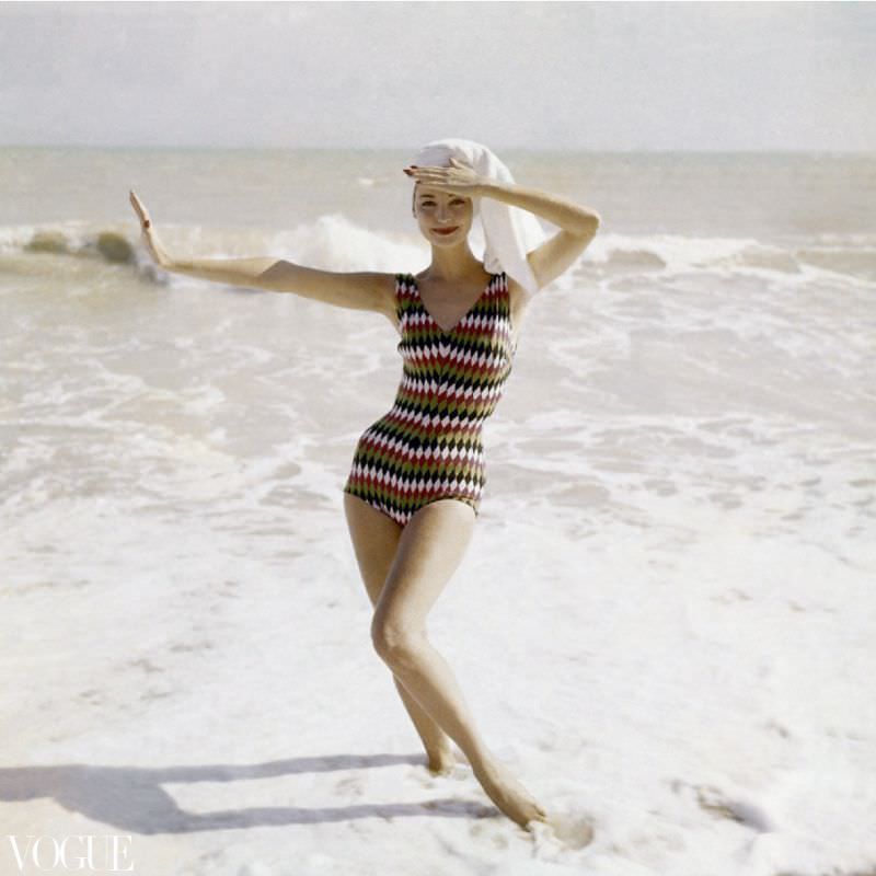 #25 Model standing on beach wearing a bathing suit in harlequin-diamond wool, by Imports Int., 1957