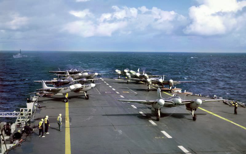 #6 A group of eight de Havilland Sea Hornets of the Fleet Air Arm line up on the flight deck of the Royal Navy aircraft carrier HMS Implacable (R86) during a sea exercise in July 1950