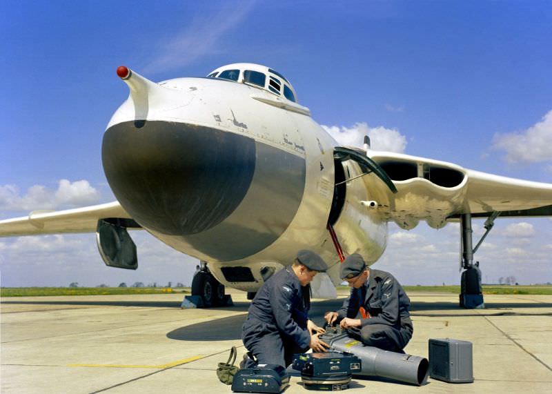 #27 Two senior aircraftmen check an F.52 camera before placing it in a Vickers Valiant B(PR).1 aircraft of No. 543 Photo Reconnaissance Squadron RAF’s base at Wyton, Cambridgeshire, 1959