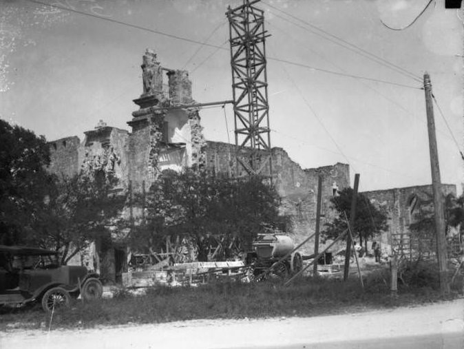#148 Exterior view of San Jose y San Miguel de Aguayo Mission during the restoration of the tower, 1928