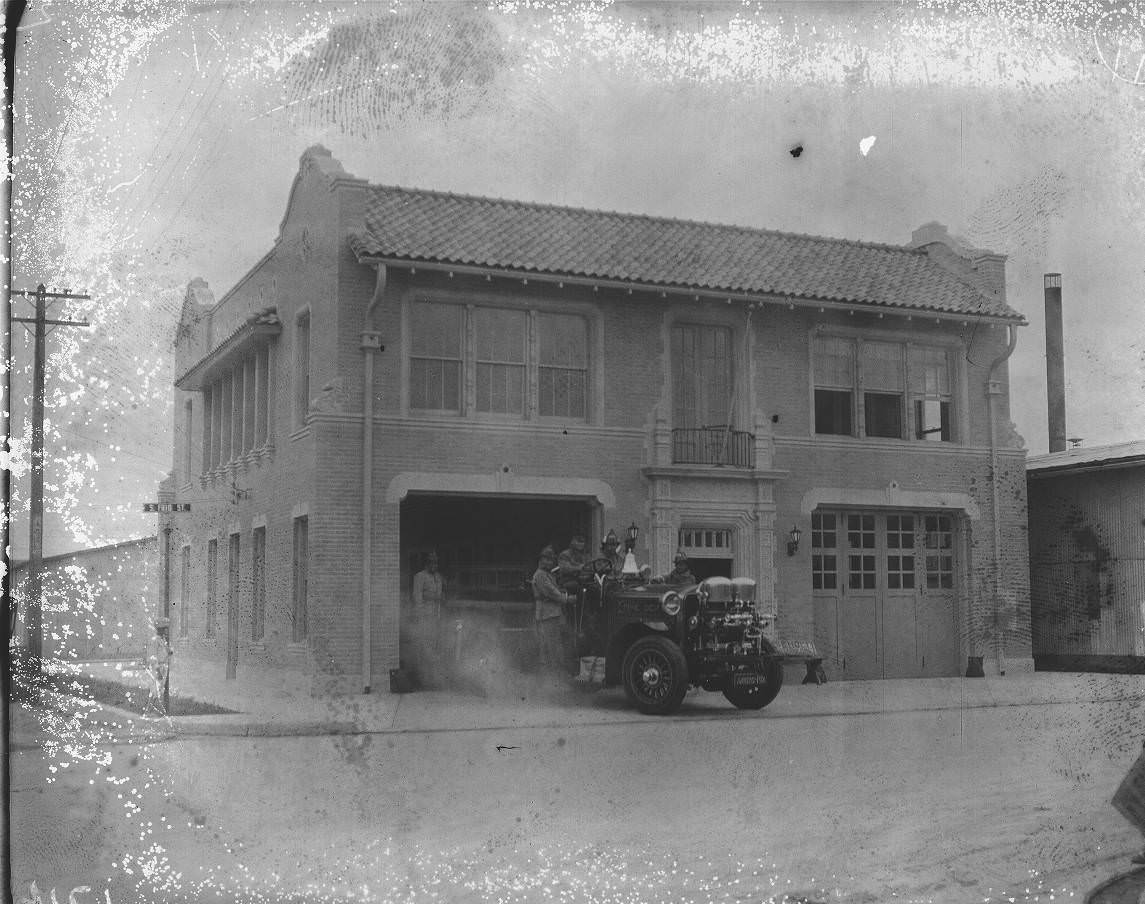 #156 Fire Station No. 11 at the corner of Frio and Matamoros Streets with firemen and a fire truck on the drive, 1925