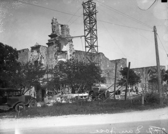 #11 Exterior view of San Jose y San Miguel de Aguayo Mission during the restoration of the tower, 1928
