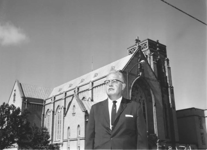 #12 Portrait of Dr. R.E. Braulick in front of St. Johns Lutheran Church, 1925