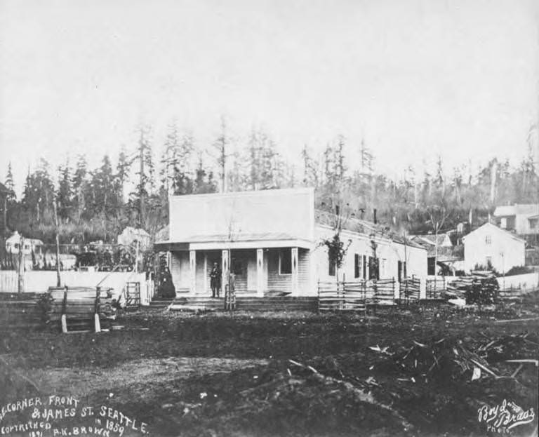 #71 Northeast corner of Front and James St., Seattle, showing Henry L. and Sara Yesler on porch of their house, Seattle, 1859