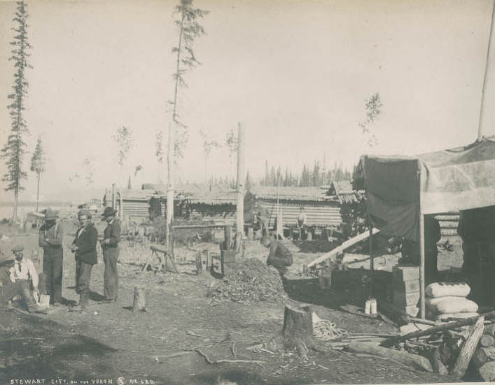 #223 Men and log cabins at Stewart City, Yukon, 1899