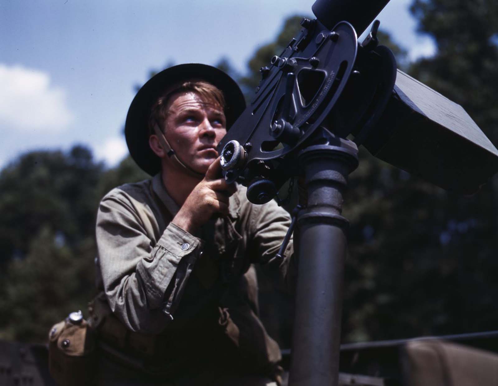 #12 An infantryman takes aim with a Browning machine gun.