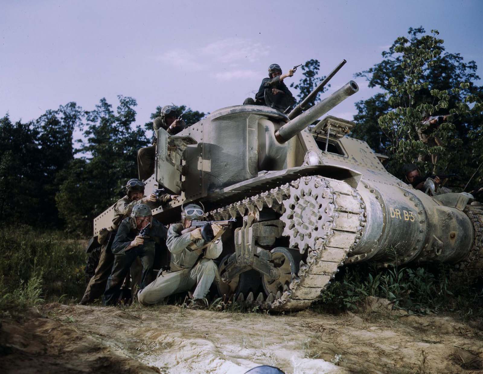 #7 An M3 tank crew aim small arms.
