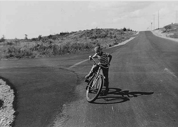 #49 Craig Hook riding bike in Norwood Village, Bellevue, 1958