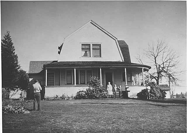 #65 Delbert Hutchison taking picture of family in front of Hutchison residence, Bellevue, 1963