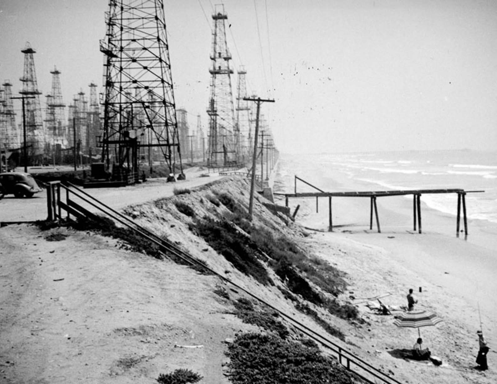 #16 Oil derricks and bathers on Huntington Beach, 1937