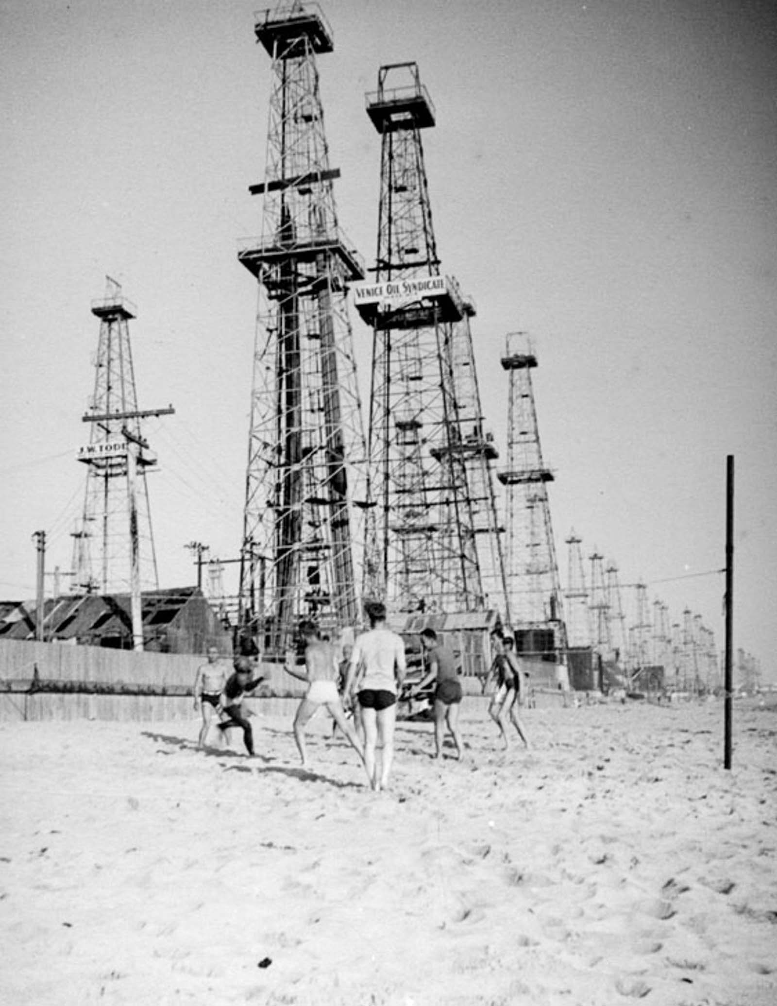 #23 Men play volleyball on the beach next to the Venice oilfield, 1937.
