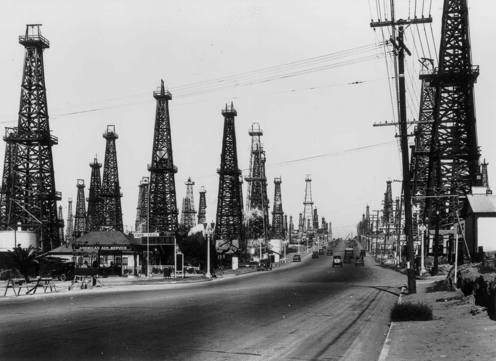 #26 Oil derricks line a road outside Los Angeles, 1930