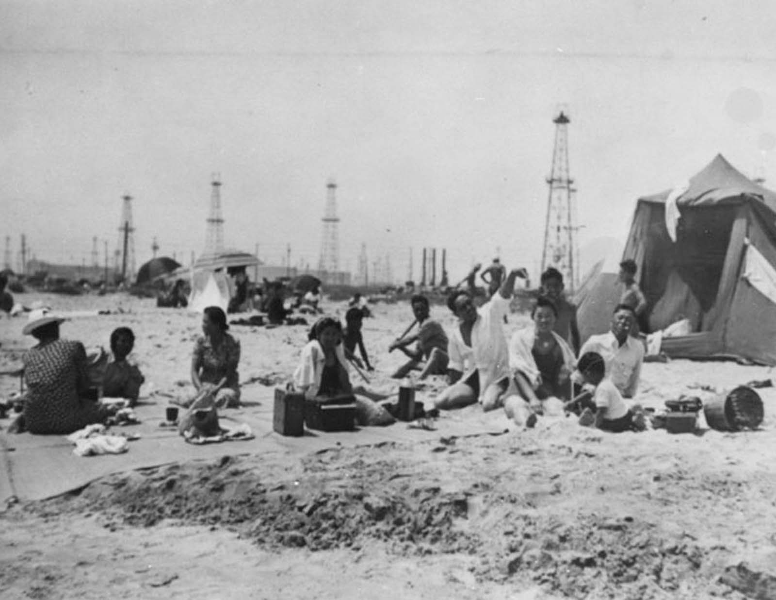 #10 A family beach picnic with Signal Hill oil derricks in the background, 1920