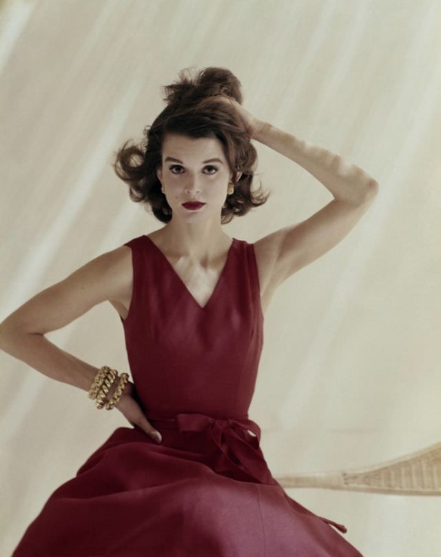 Model is wearing a red linen Anne Fogarty dress and jewelry by Tiffany &; 1960