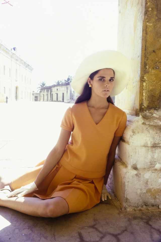 #23 Ali MacGraw wearing an orange suit, March 1967