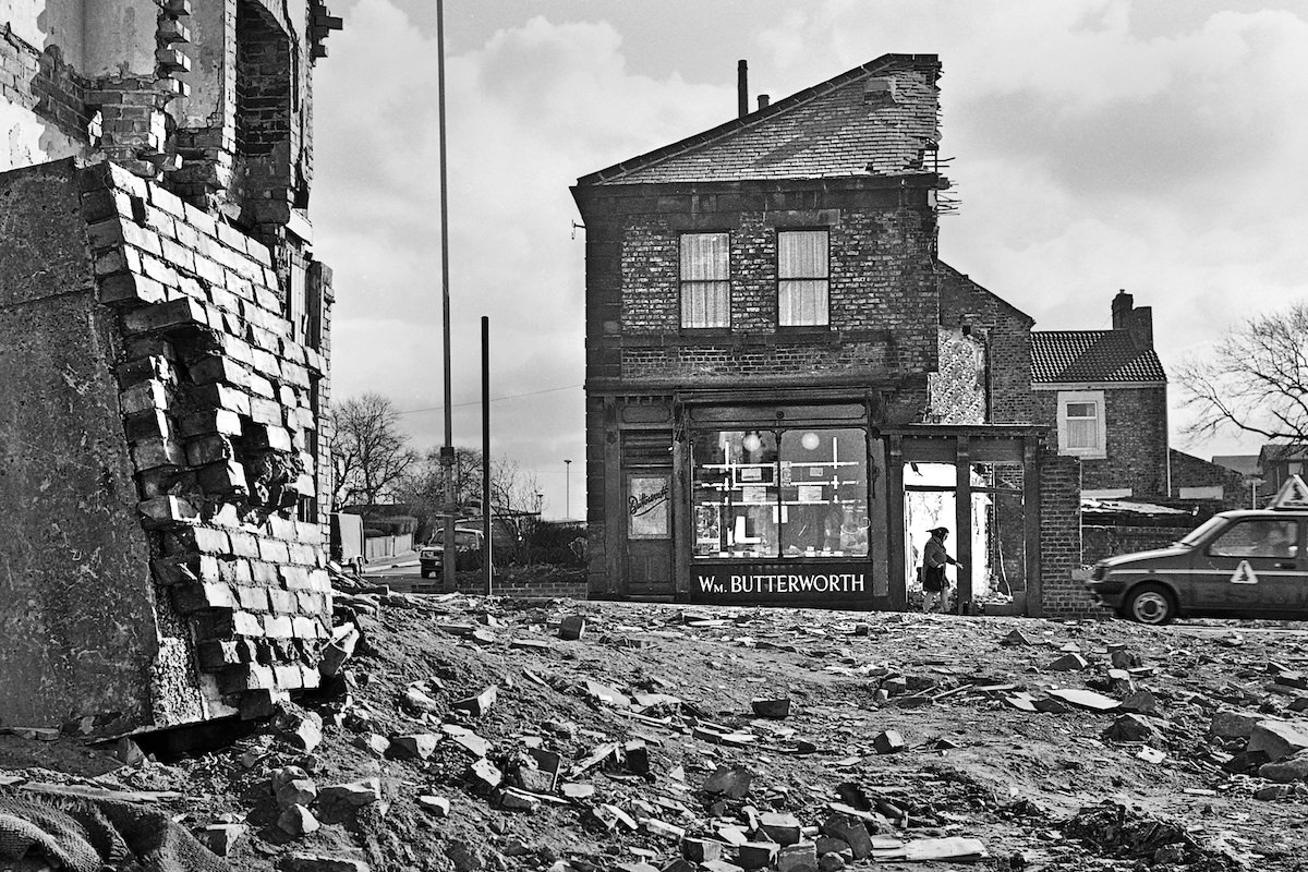 #18 Wm Butterworth, butcher, is still open, even as the demolition goes on around him in 1982