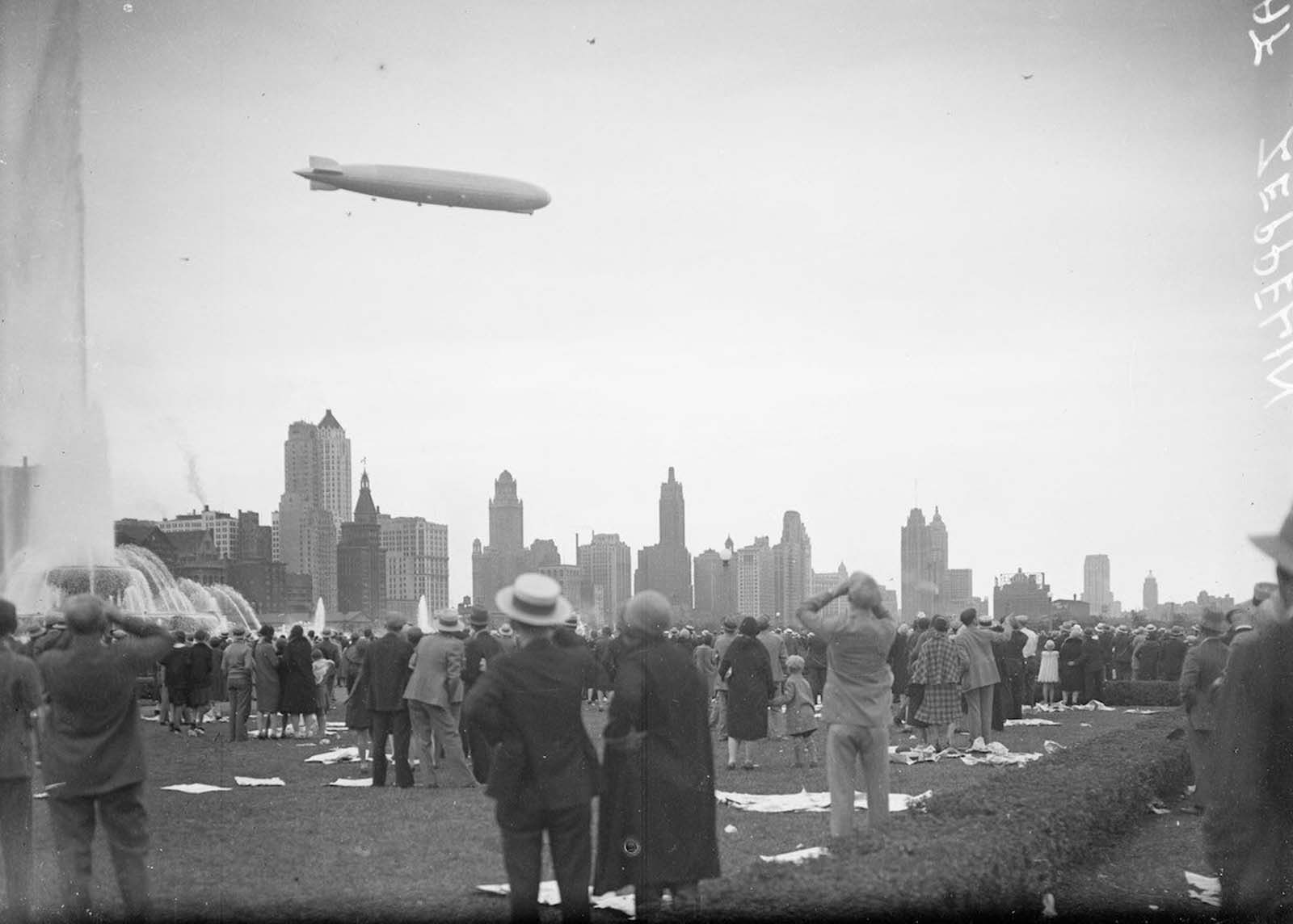 #6 The Graf Zeppelin viewed in profile flying at a downward angle over Buckingham Fountain in Grant Park.
