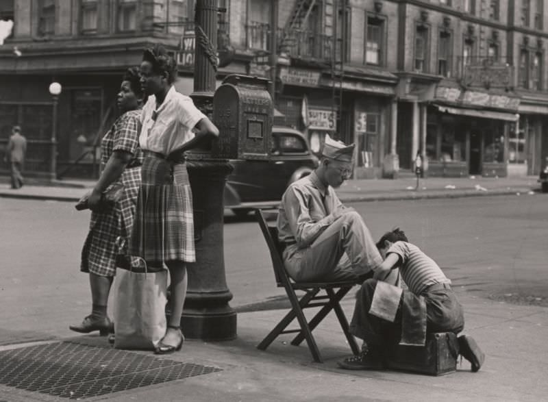 #12 A soldier getting a shoe shine on 125th Street, 1946