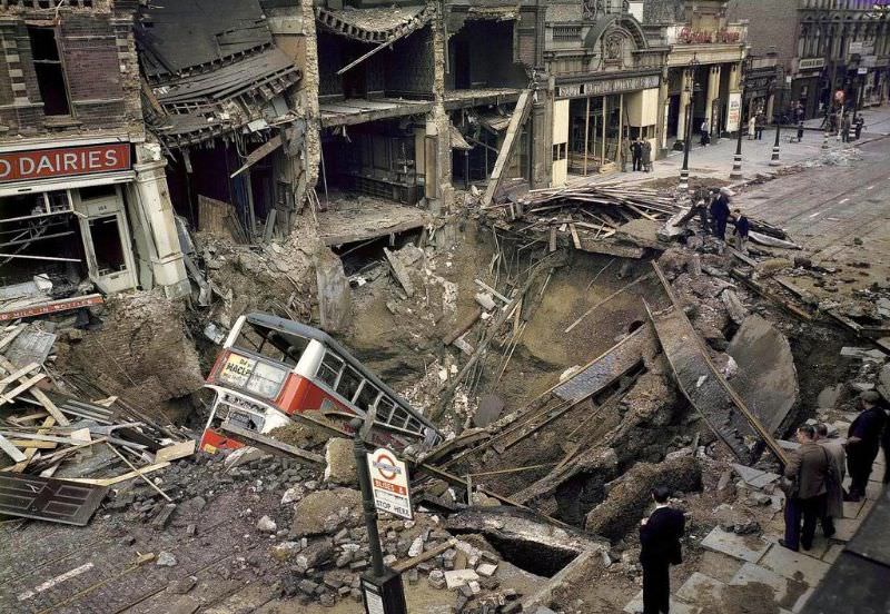#1 A bus is laying inside a huge bomb crater in a London street after heavy German air raid bombing attacks during the Battle of Britain, October 15, 1940