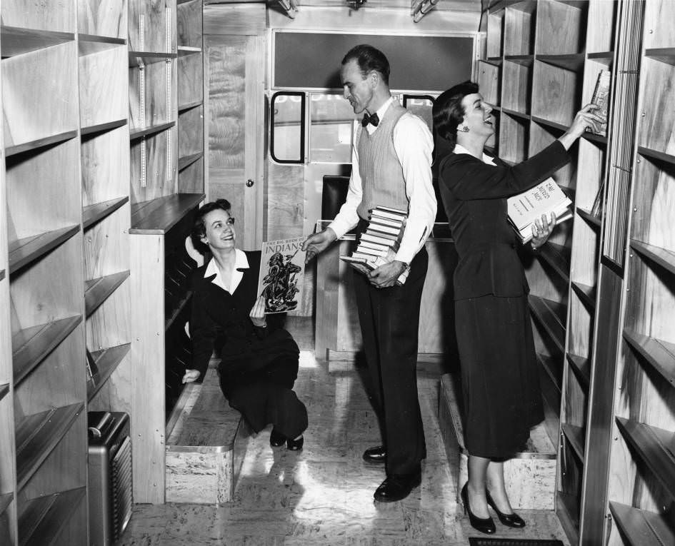 #107 Nashville Public Library staff members shelving books in the bookmobile, 1955