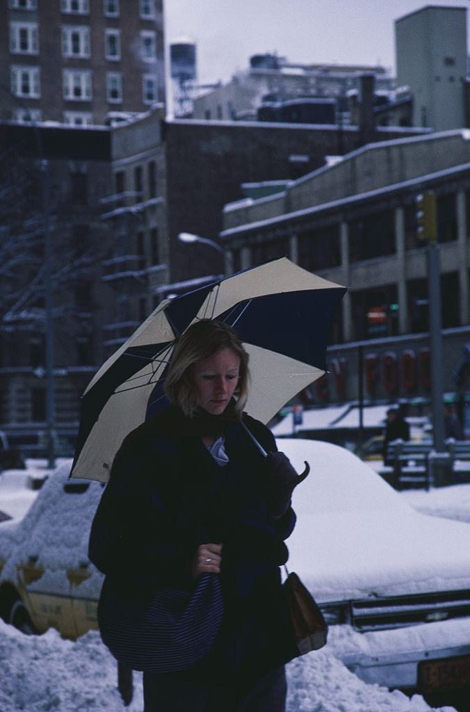 #6 A woman walking down a street in New York City, during the blizzard of January 1996.