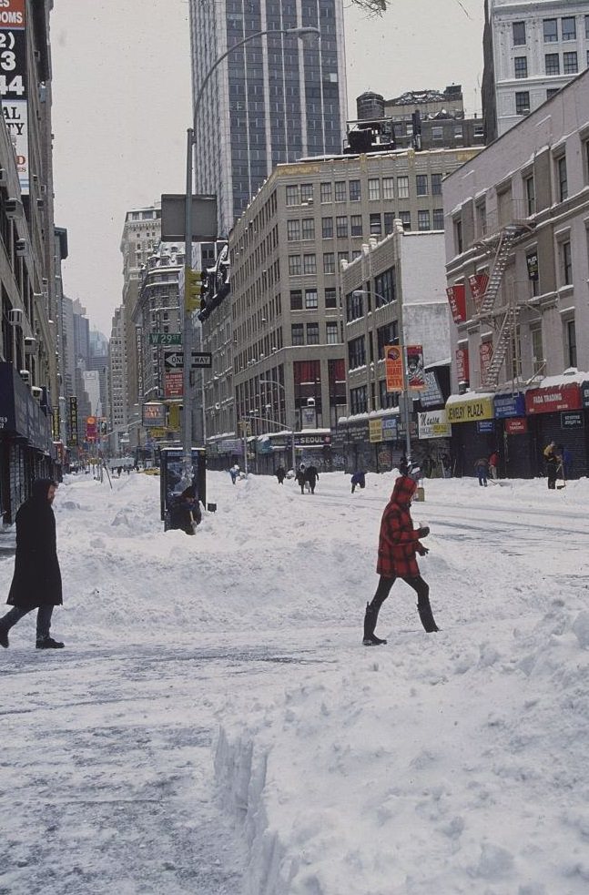 #12 Pedestrians Walking Across Snow-Covered Street