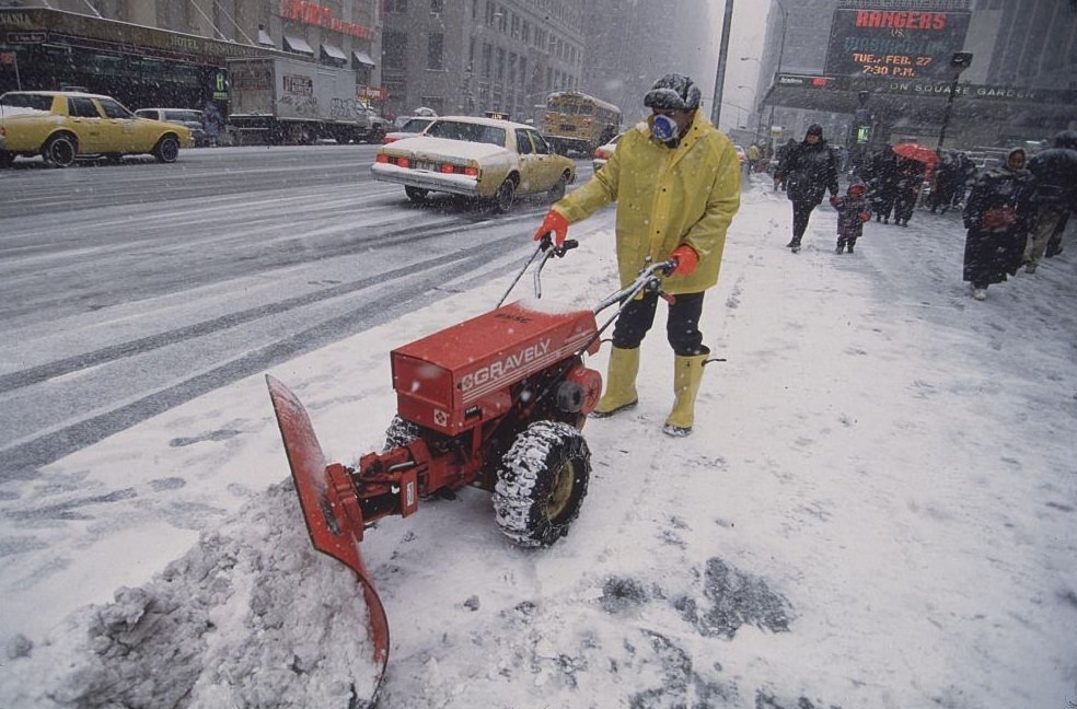 #33 Man in Yellow Coat and Boots Using Electric Snowplow, 1996