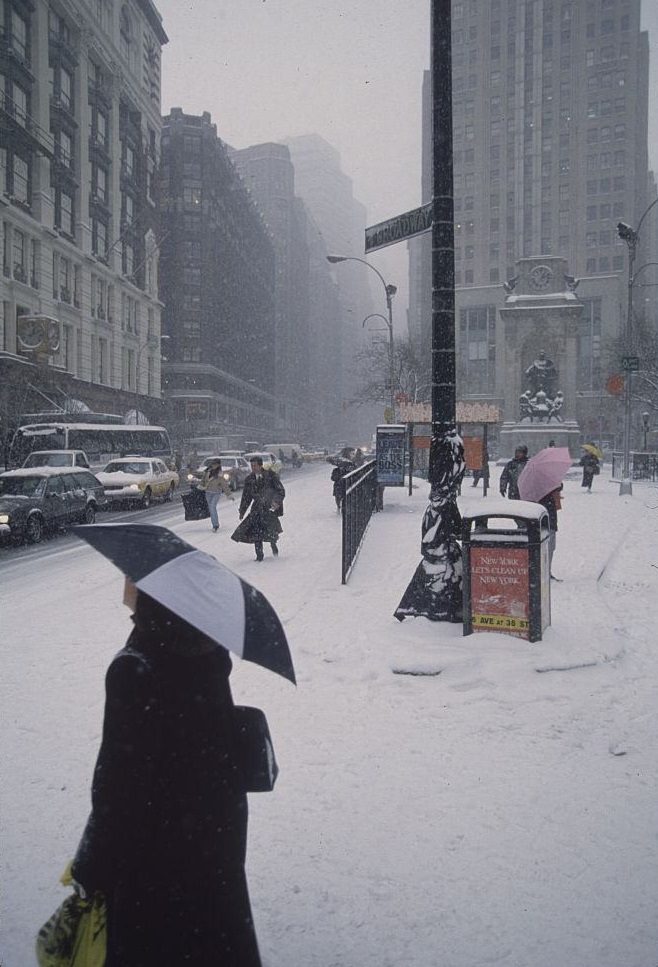 #13 Pedestrians Carrying Umbrellas on Street During Snowstorm, New York City, 1996